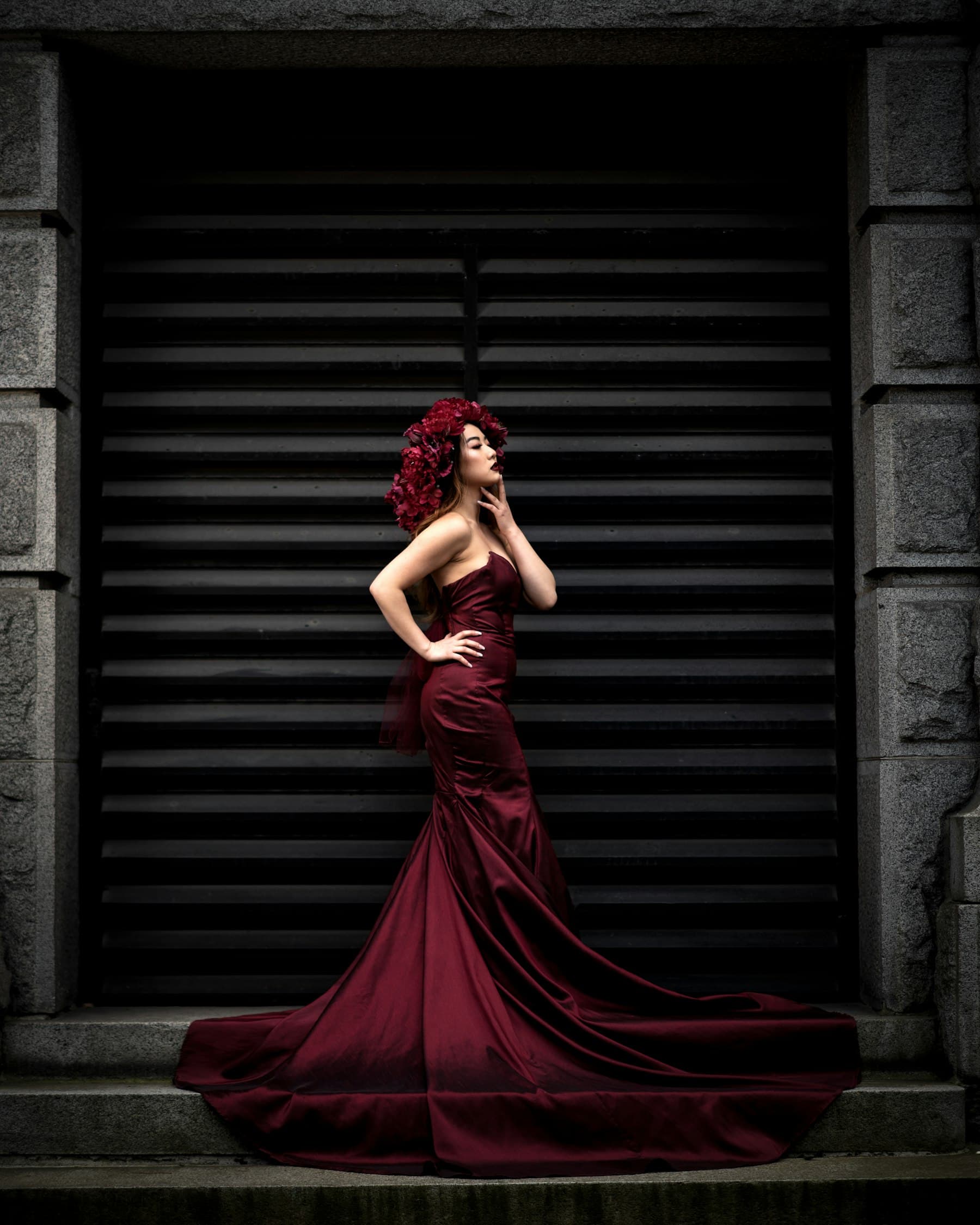 Model in a burgundy satin gown