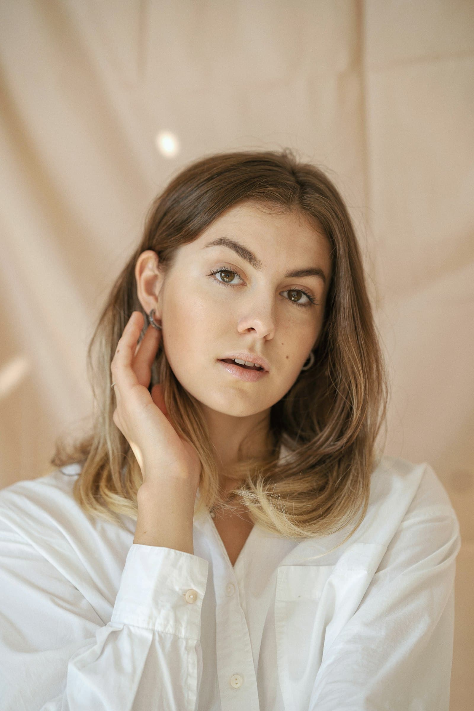 Close portrait of a model in an ivory shirt