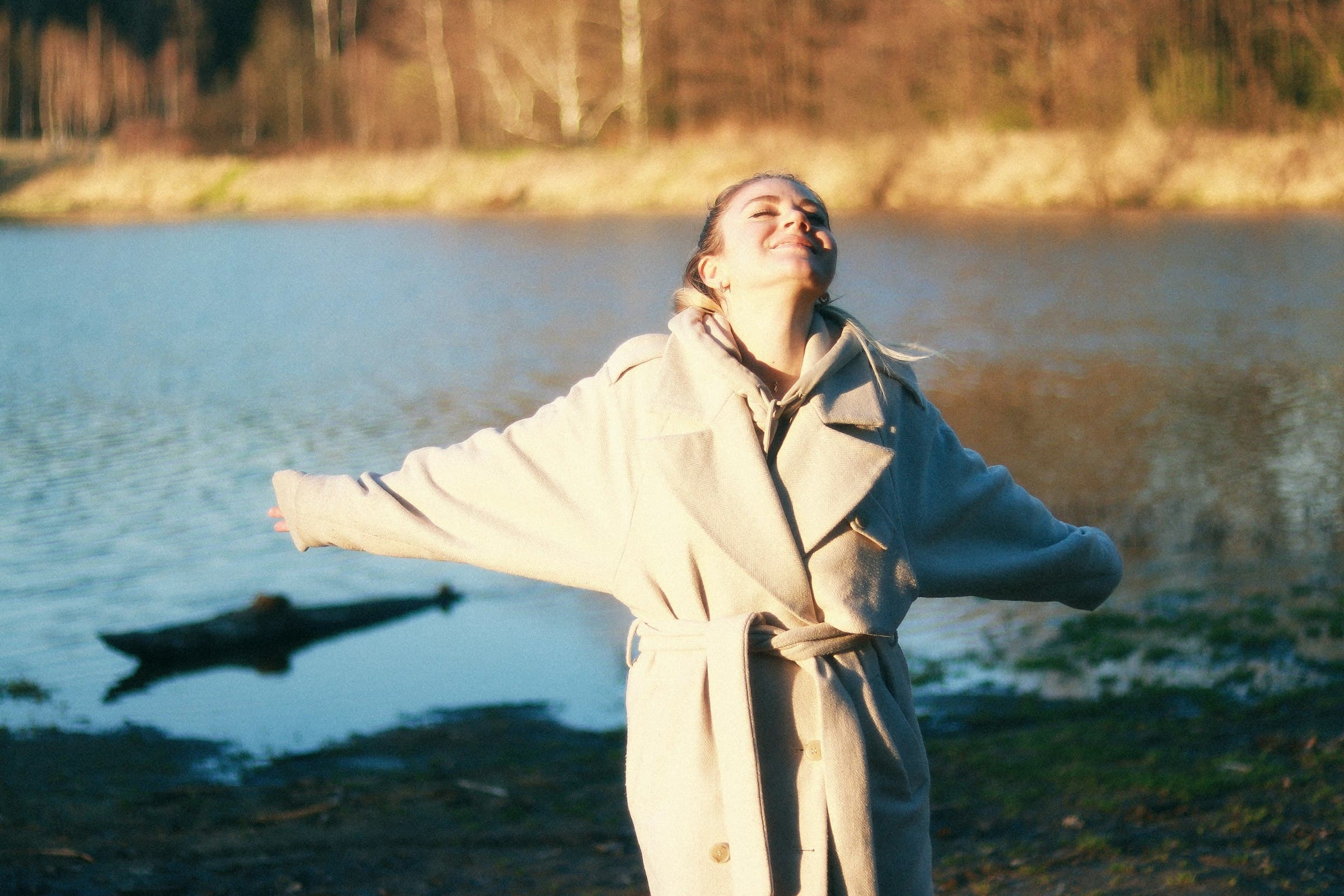 Model in an ivory coat turning into warm light