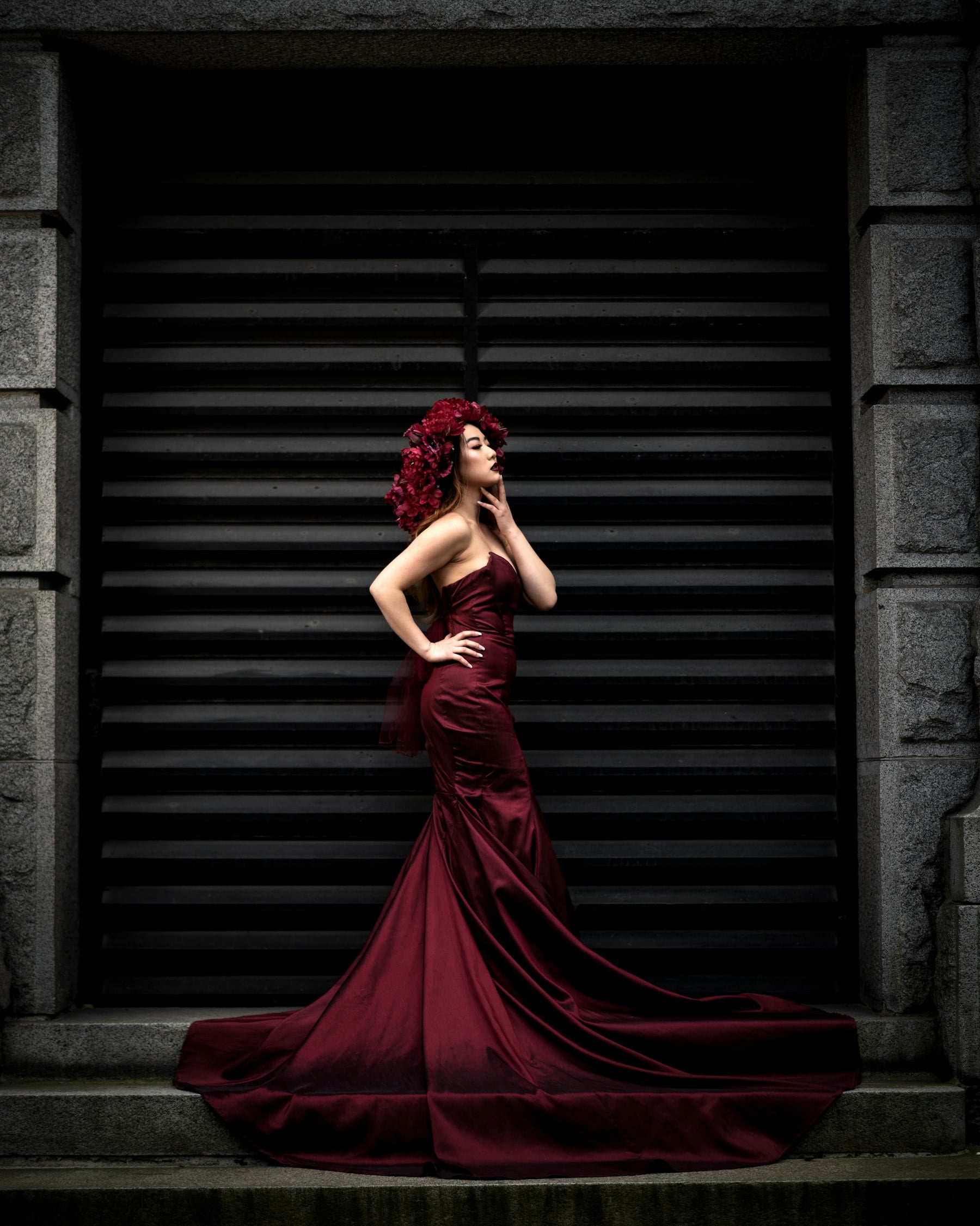 Model in a burgundy satin gown